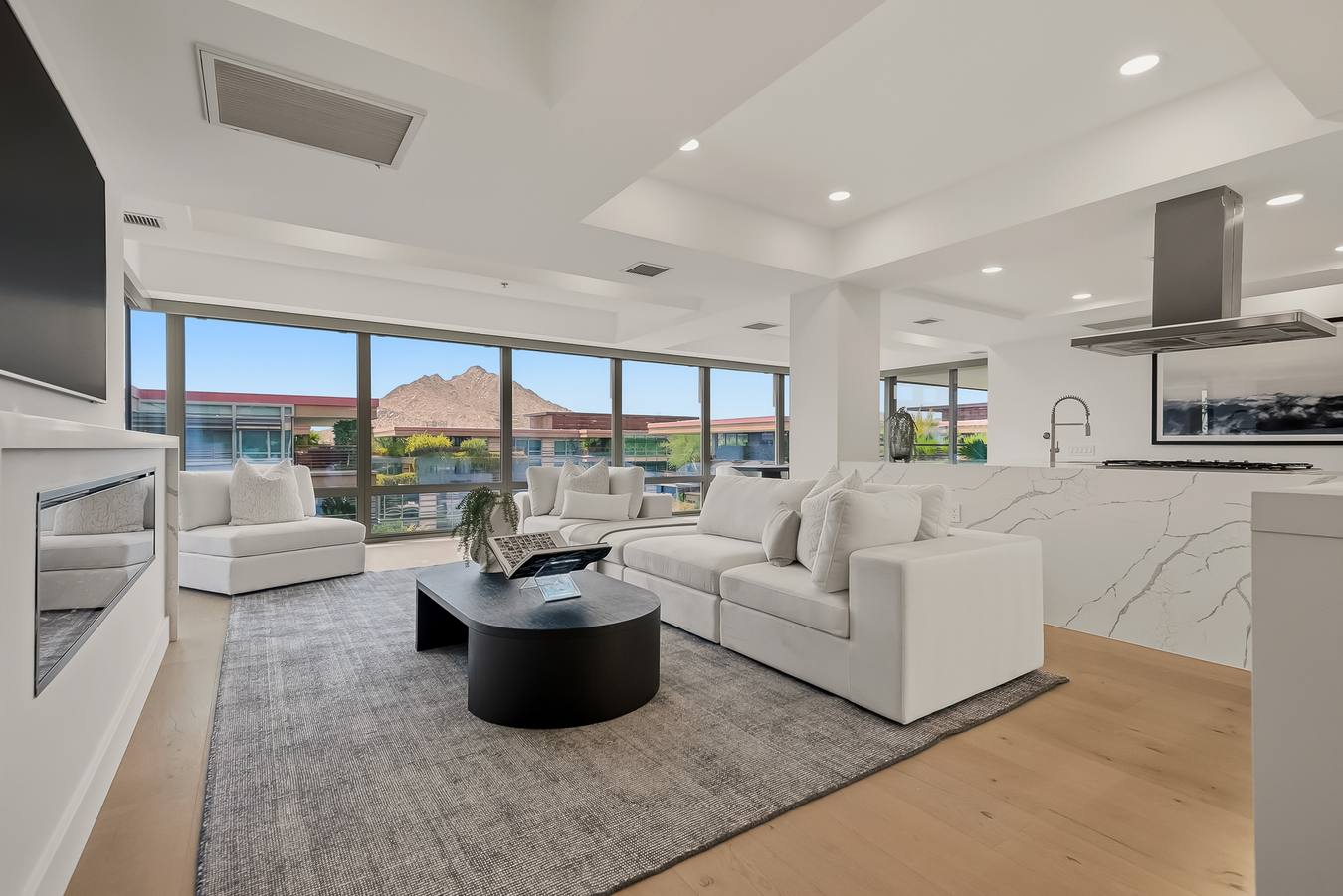 Living room with fireplace and mountain views