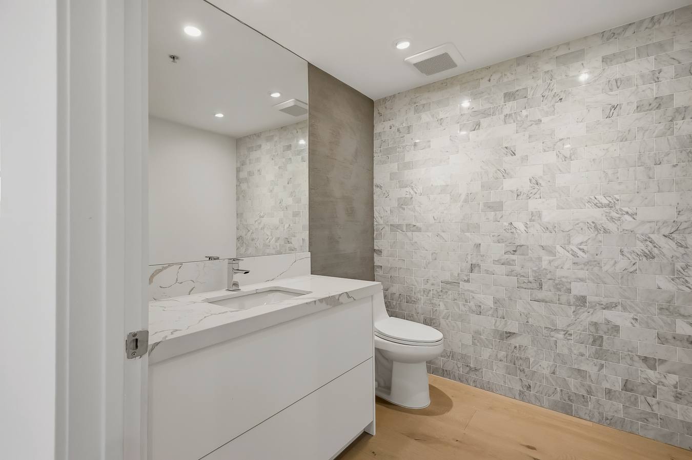 Powder bath with Carrara accent wall